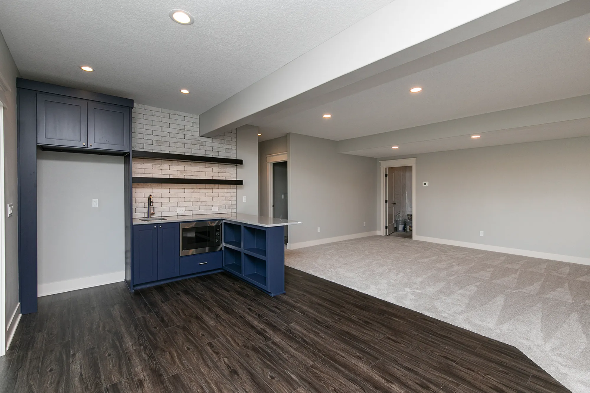 Gray Quartz Basement Wet Bar with Navy Cabinets